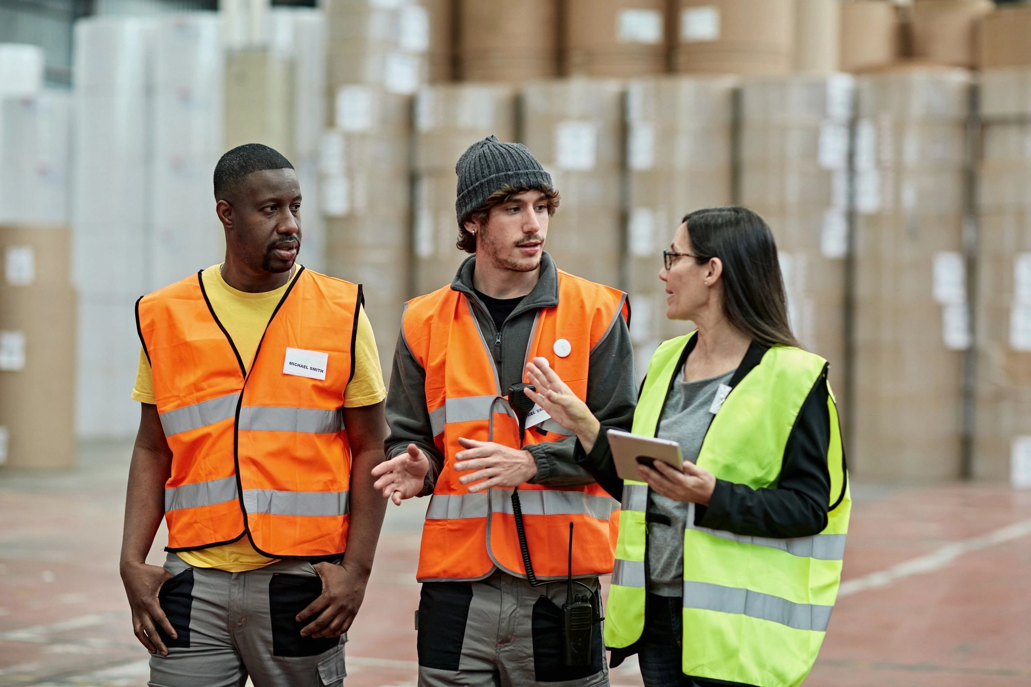 Warehouse supervisor discussing plans with logistics team