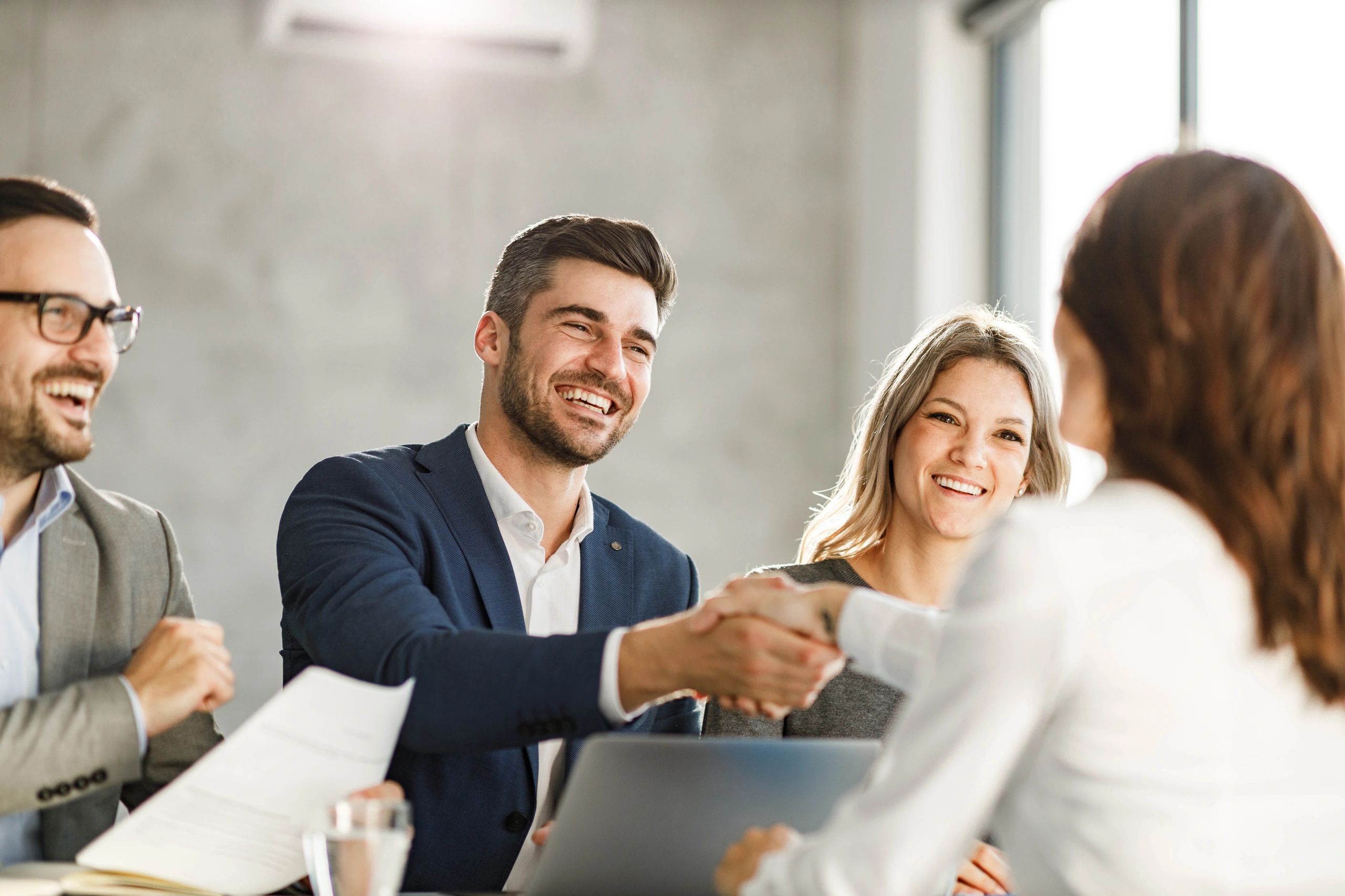 Business colleagues shaking hands after agreeing on staffing plan