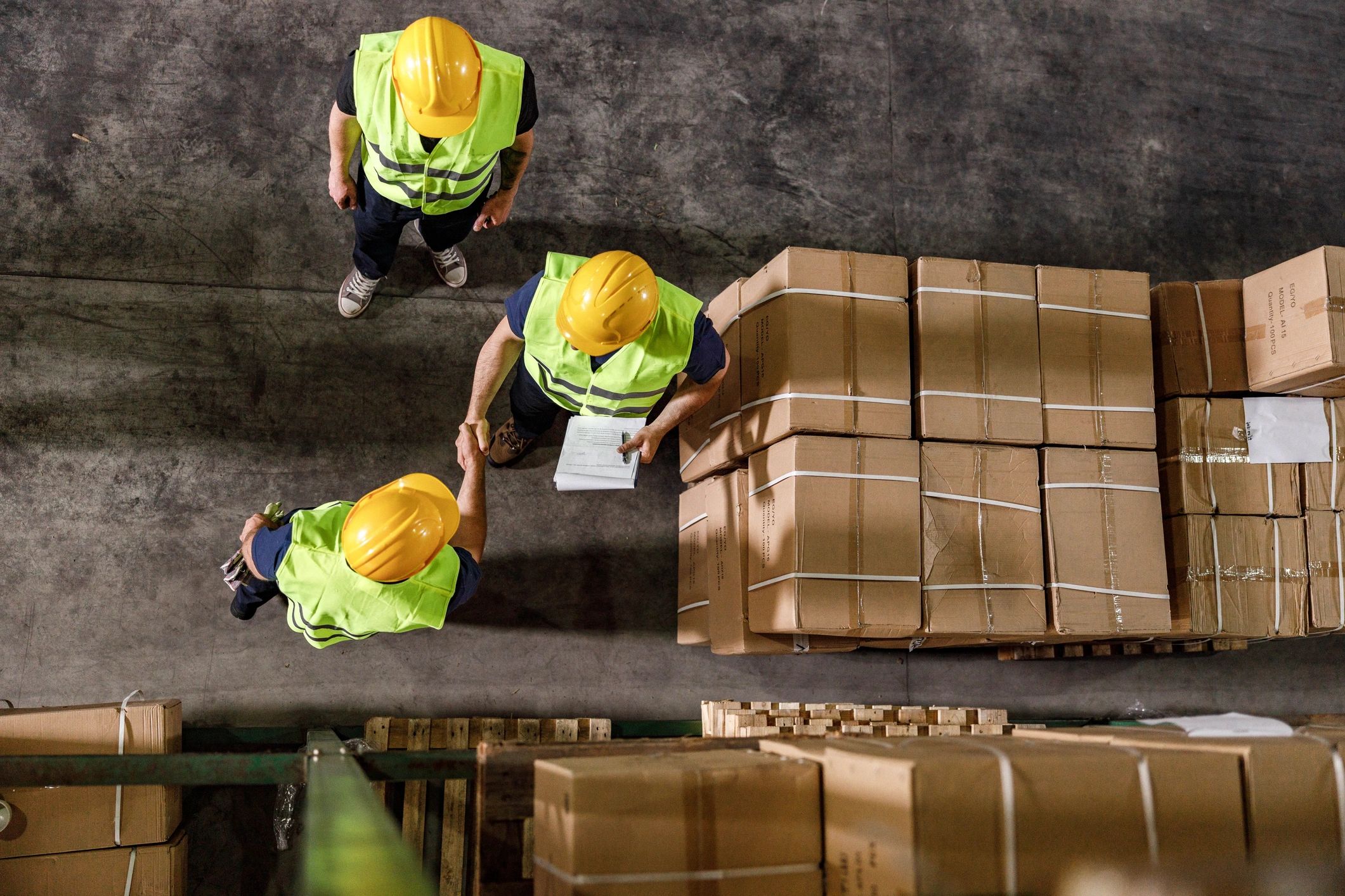Warehouse colleagues shaking hands, symbolizing partnership