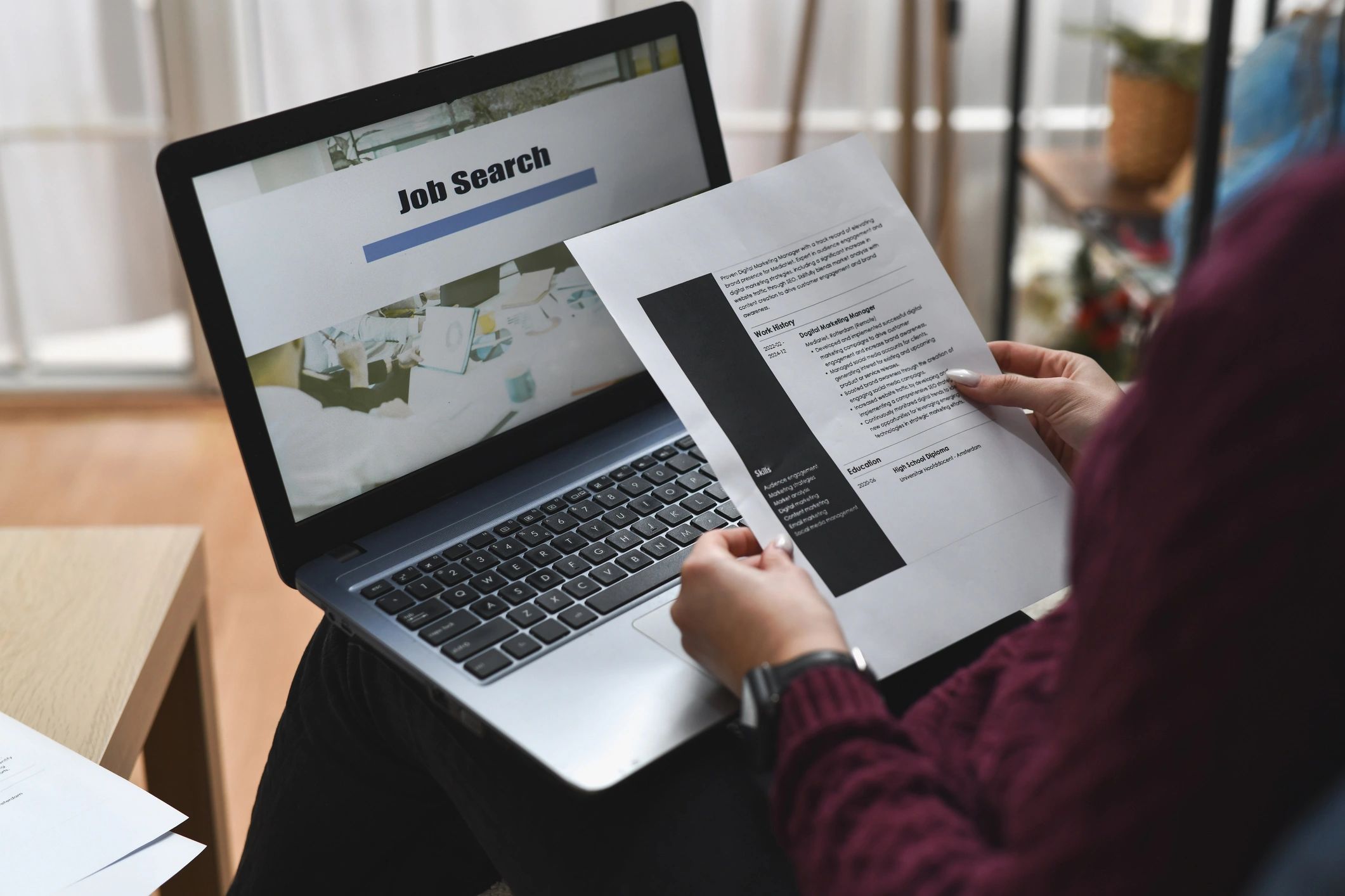 Hands holding a printed CV