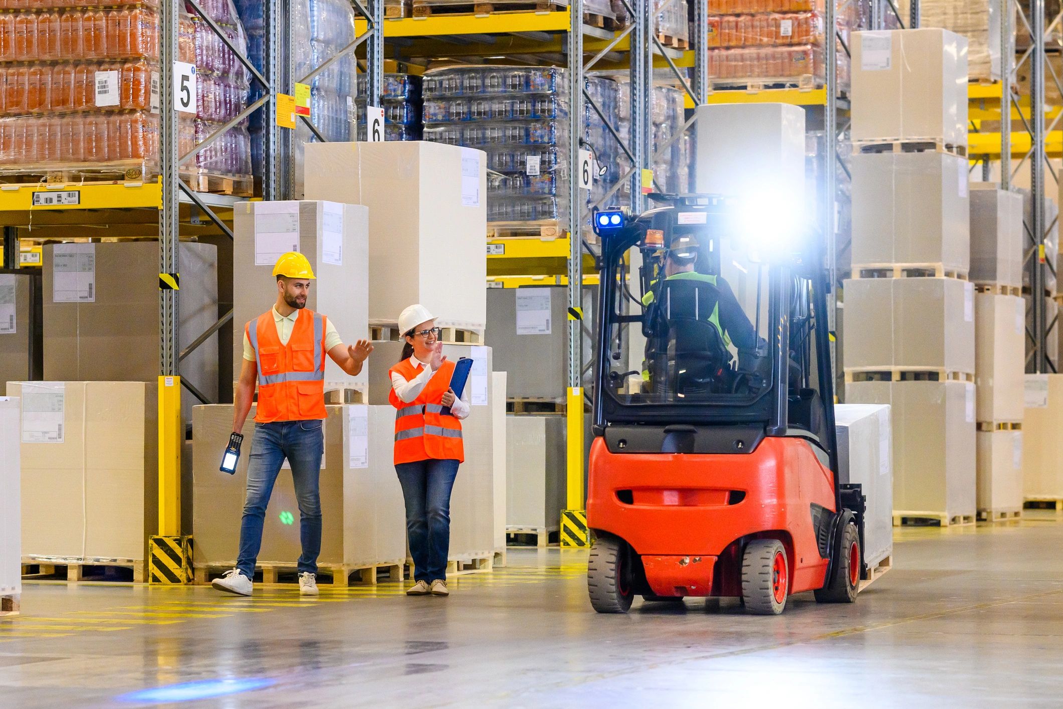 Warehouse workers coordinating logistics in a distribution warehouse