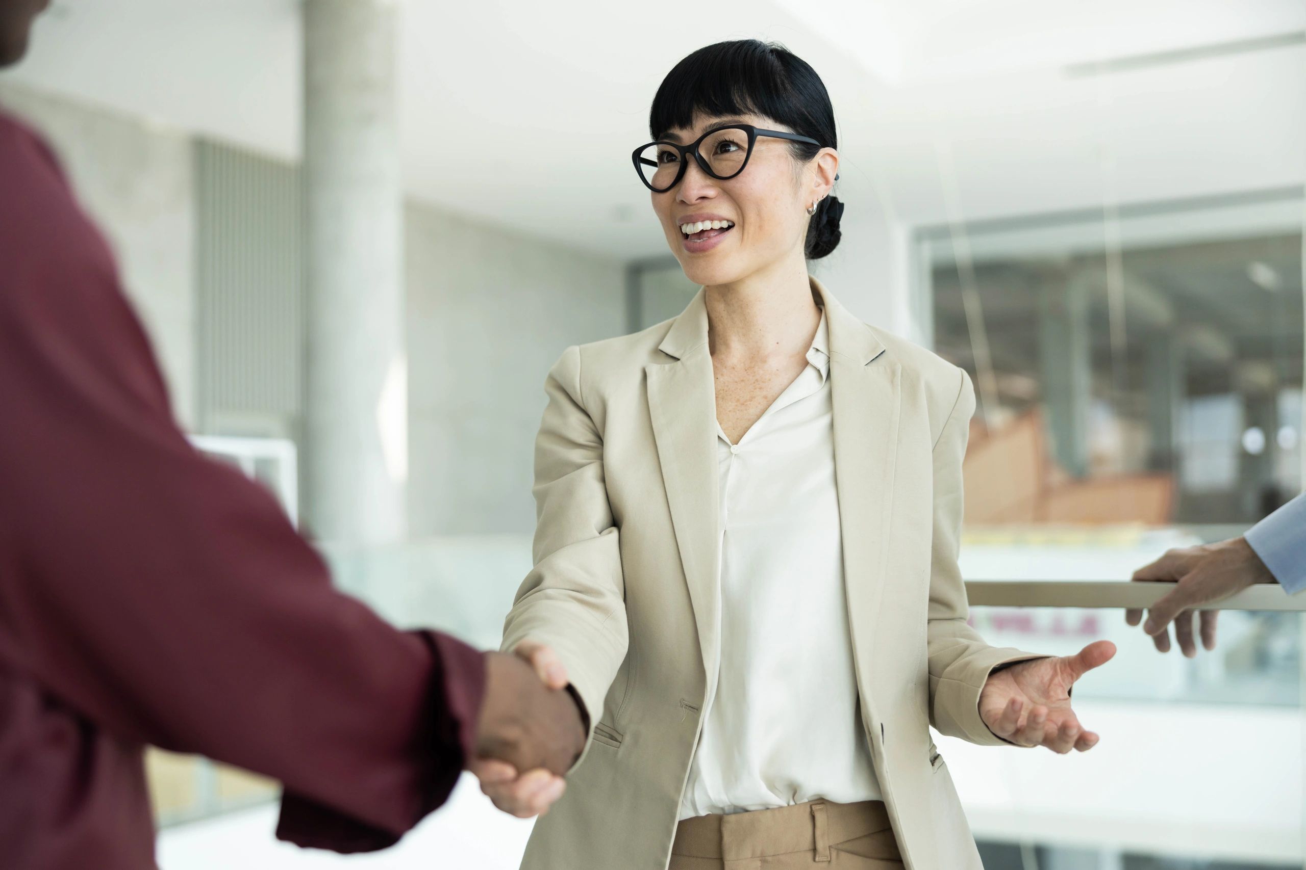 Business professionals shaking hands during an office meeting